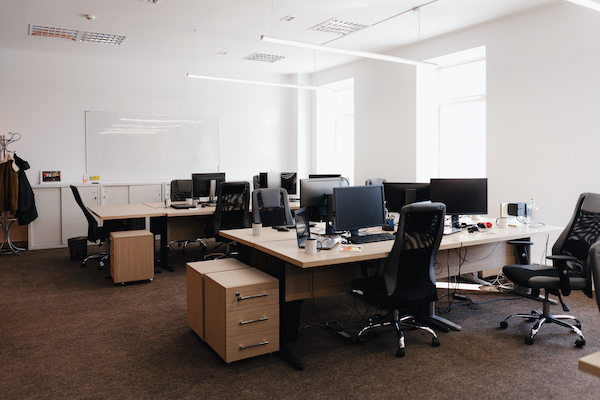 Empty office with desks, chairs and computers